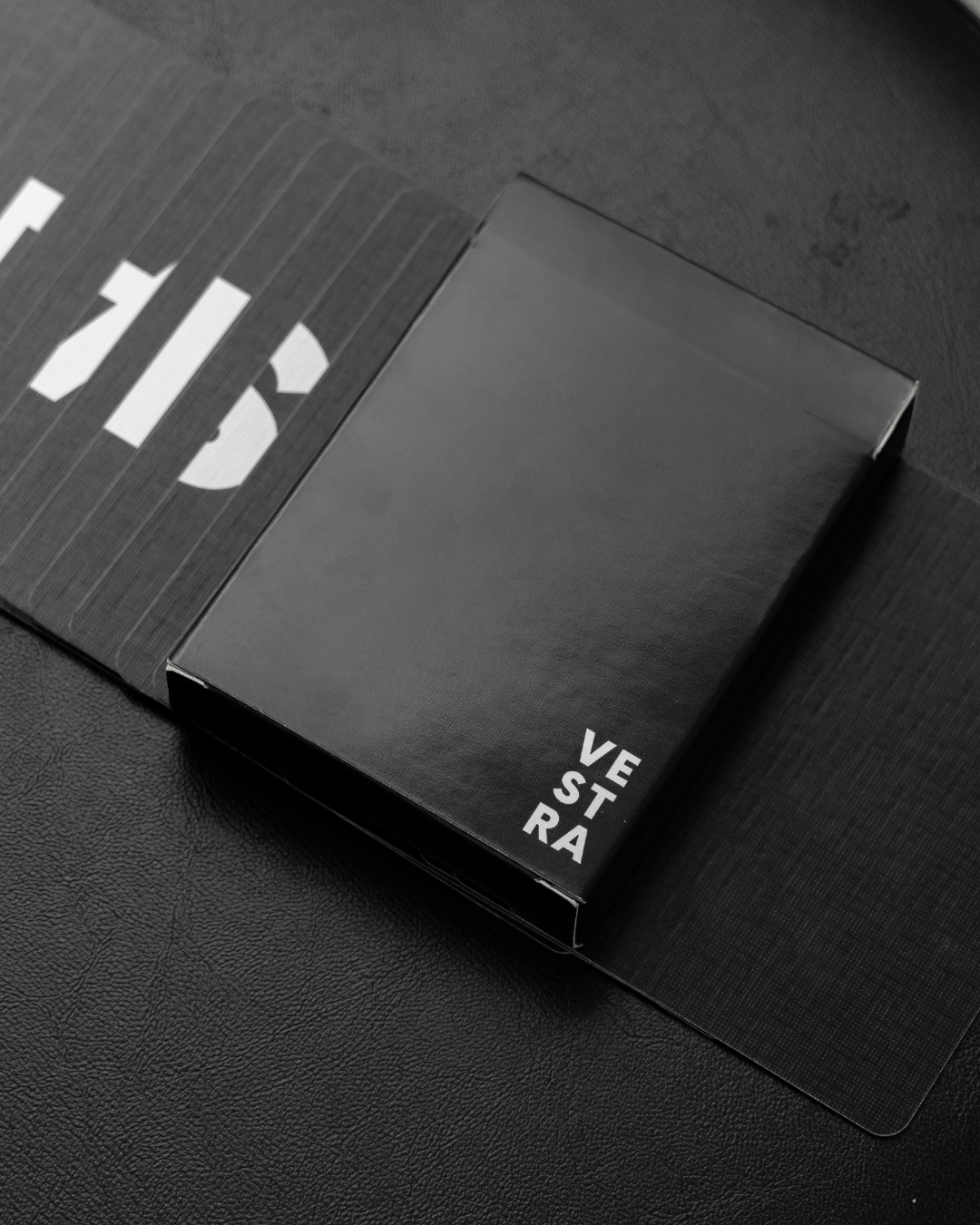 Vestra cardistry deck laying on black playing cards