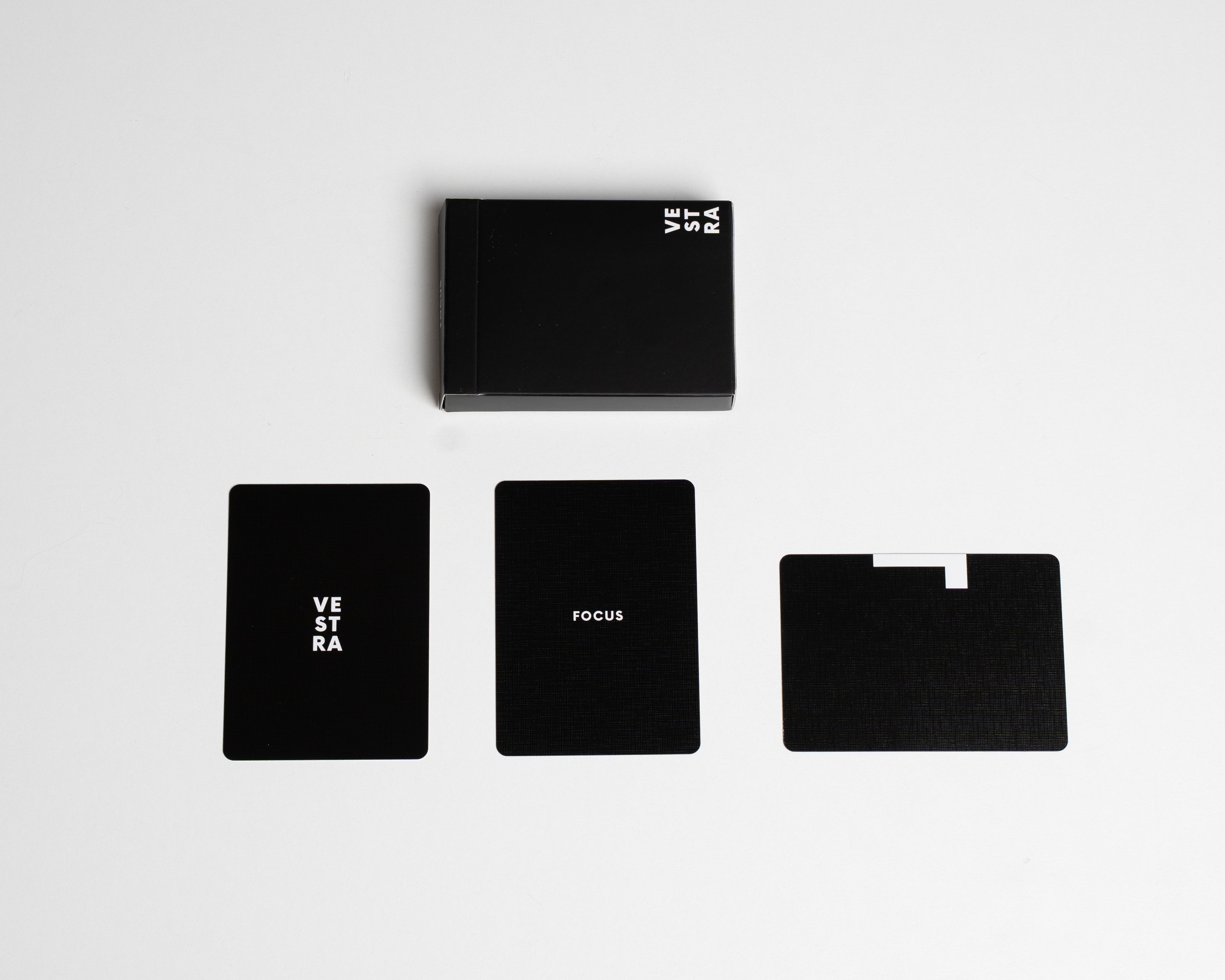 Set of black cardistry cards with 'VESTRA' branding on a white background
