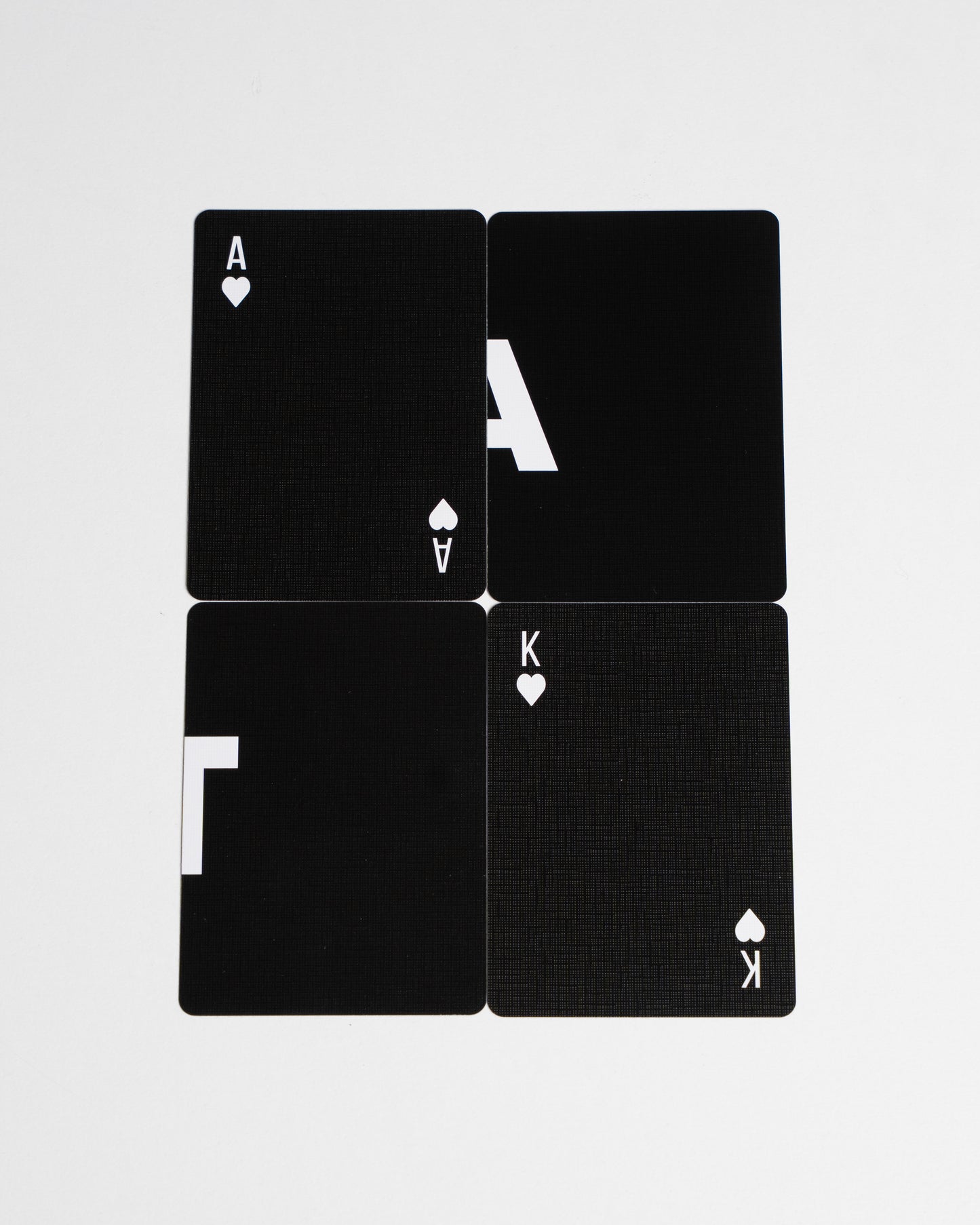 Black playing cards with white symbols on a white background