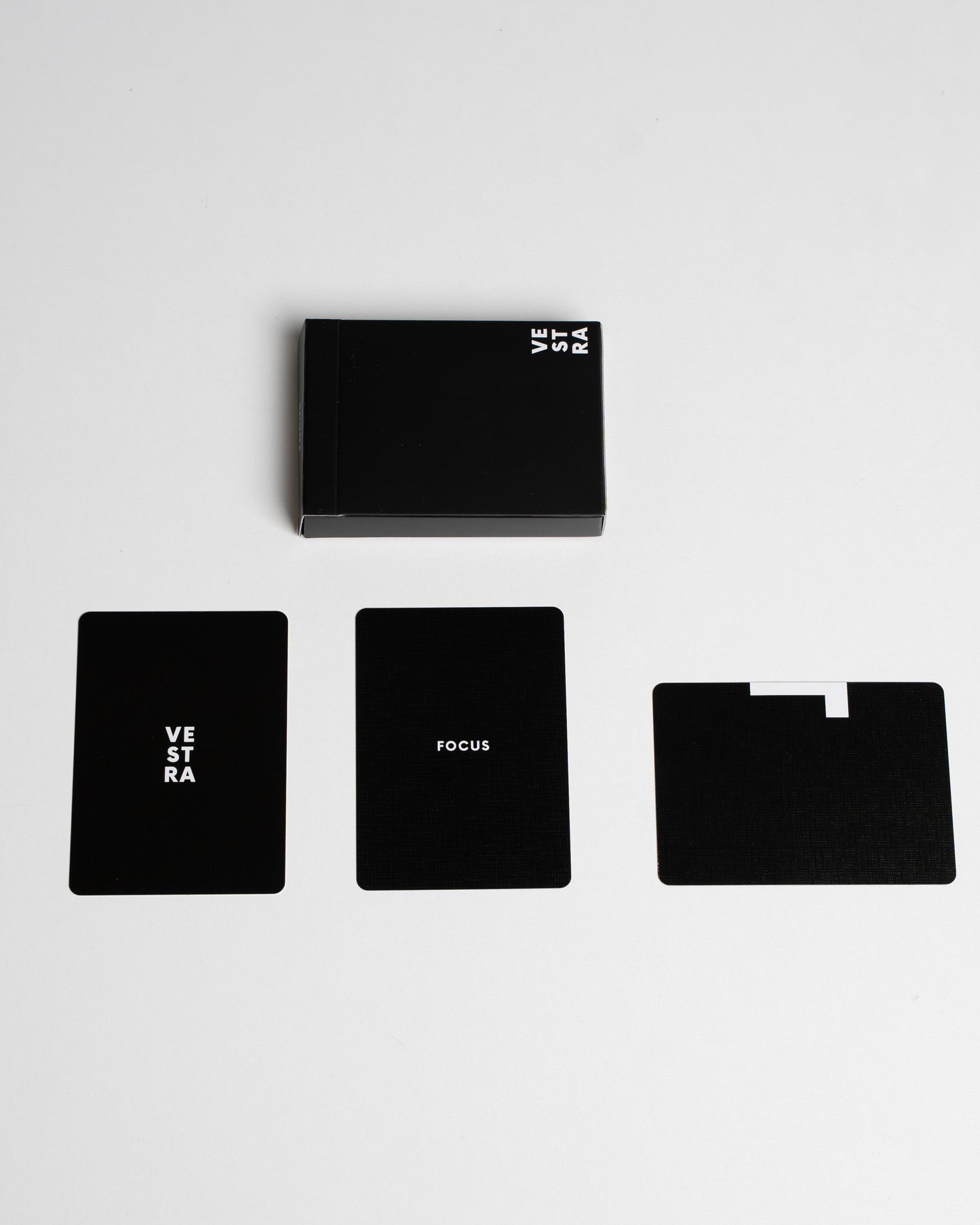 Set of black cards with 'VESTRA' branding on a white background